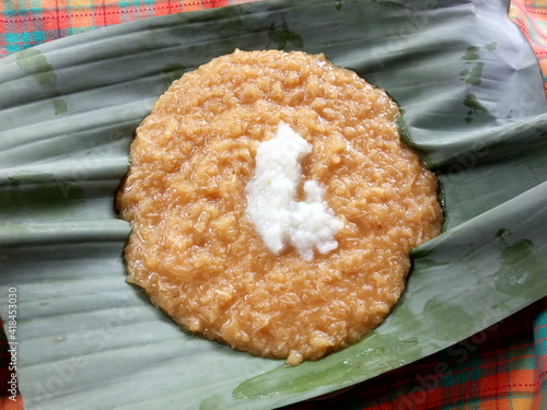 Jenang abang or Javanese Indonesian Porridge plated on green Banana Leafs. Red Porridge. photo