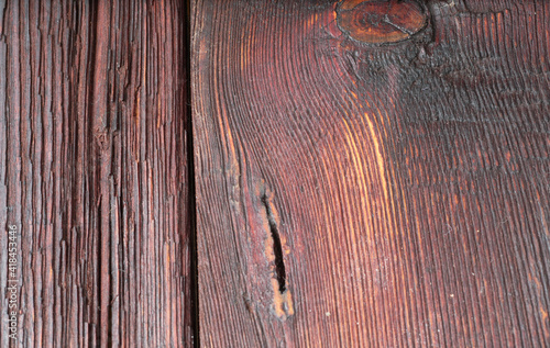 The old brown wood texture with holes, bitches and cracks. Natural fiber pattern close up. Macro shot of wooden boards. photo