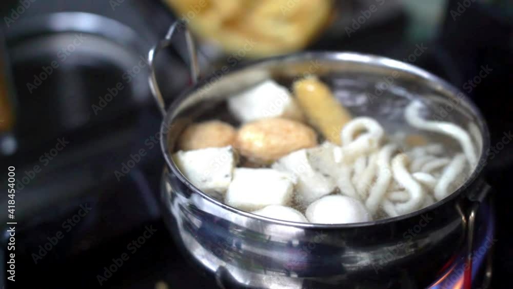 Close-up shot of the hands of senior chef cooking tom yum, making tom yum using traditional recipes, isolated on 4k footage Close-up shot of the hands of senior chef cooking tom yum, making tom yum using traditional recipes, isolated on 4k footage