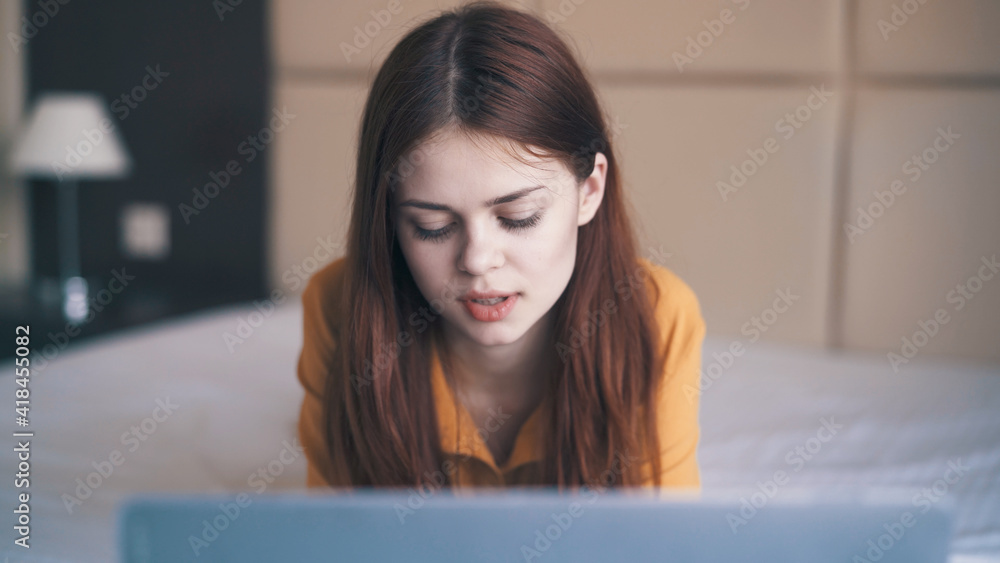 pretty woman with laptop lies in bed close-up internet pretty woman with laptop lies in bed close-up internet