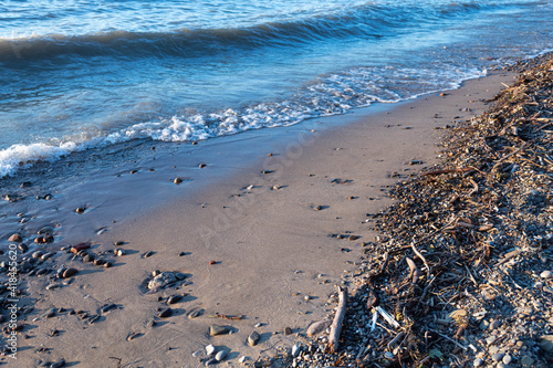 Bright blue waves near the sand photo