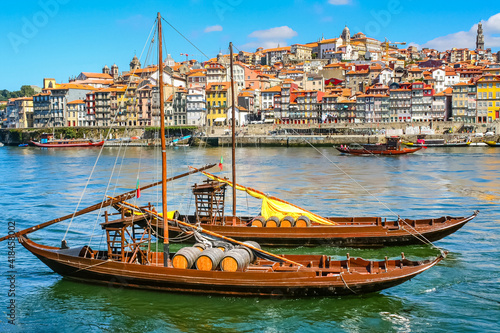 Cityscape of the city of Porto, Douro river with its old boat and its typical colored houses on the water's edge. Portugal.