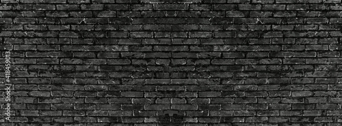 Old vintage retro style black bricks wall for brick background and texture. 