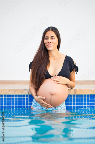 heavily pregnant woman in a swimming pool