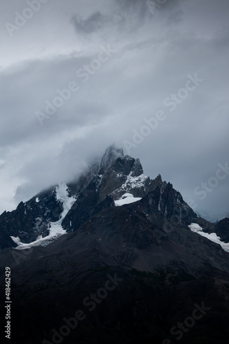 A black mountain with snow, on a cloudy and grey day © JuanJo