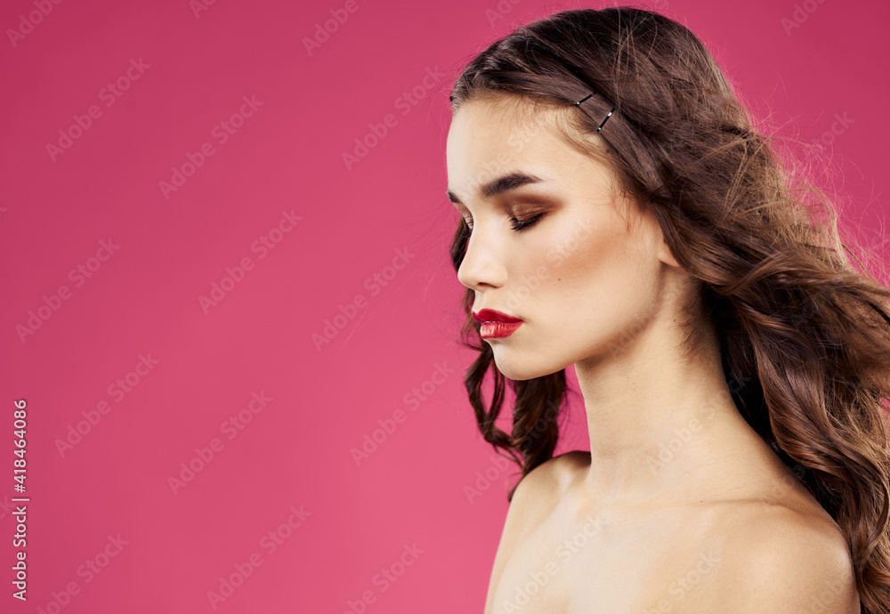 Woman on pink background with bright makeup red lips Woman on pink background with bright makeup red lips