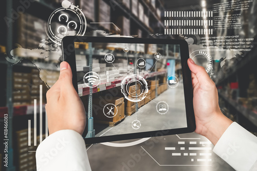Smart warehouse management system using augmented reality technology to identify package picking and delivery . Future concept of supply chain and logistic business . photo