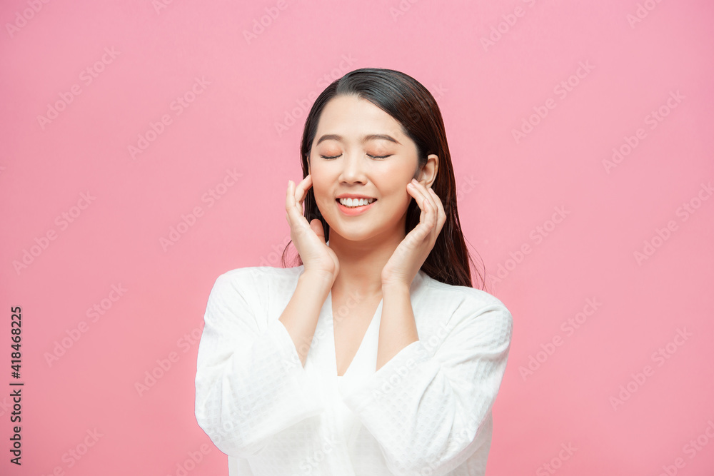 Beauty and Spa Concept. Beautiful Young Woman with Clean Fresh Skin touch own face and Smiling Beauty and Spa Concept. Beautiful Young Woman with Clean Fresh Skin touch own face and Smiling