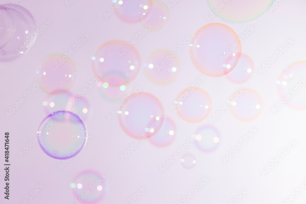 Beautiful Blur Transparent Colorful Pink Soap Bubbles Floating Background.
