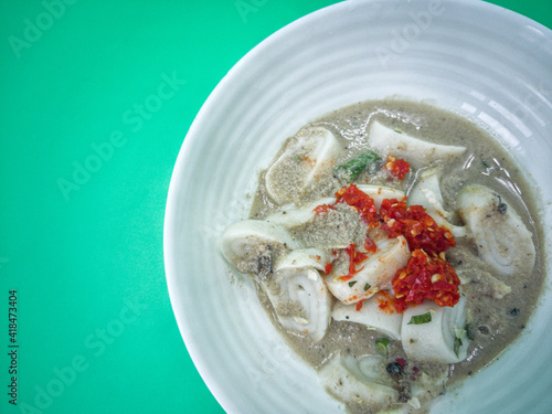 Laksam, flat rice noodle with vegetables in coconut fish gravy. Popular traditional food in East Coast Malaysia photo