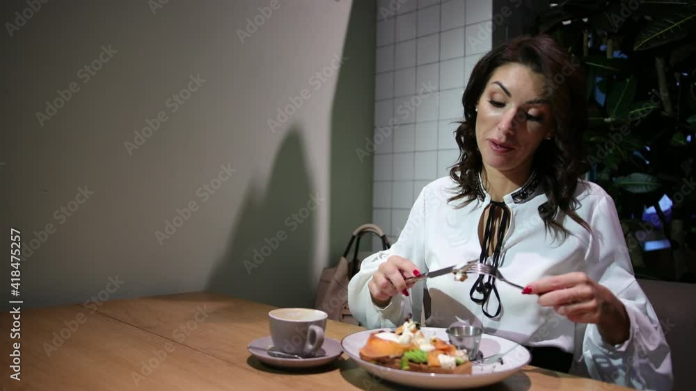 Attractive lady, woman eating salad in restaurant indoor. Celebrating alone. Smiling female meal fresh dish cafe. Portrait of a beautiful young elegant ladylove the coffee shop. Attractive lady, woman eating salad in restaurant indoor. Celebrating alone. Smiling female meal fresh dish cafe. Portrait of a beautiful young elegant ladylove the coffee shop.