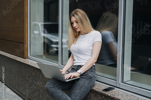 Earn extra money, Side hustle, money making, turning hobbies into cash, Gig economy, digital nomad. Young woman, student with laptop and smartphone working outside