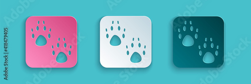 Paper cut Paw print icon isolated on blue background. Dog or cat paw print. Animal track. Paper art style. Vector.