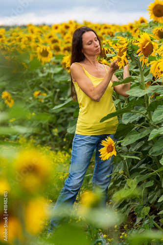 Beautiful girl in a field of sunflowers