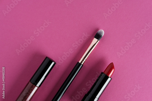 Set of makeup cosmetics on pink background.