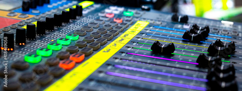 Foto Sliders and buttons on Audio Mixing Desk at live event.