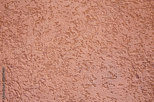 texture of red wall covered with volumetric plaster, space for text, space for copy