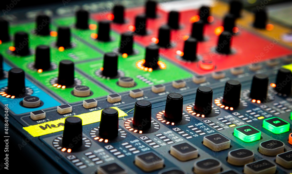 Sliders and buttons on Audio Mixing Desk at live event. Sliders and buttons on Audio Mixing Desk at live event.