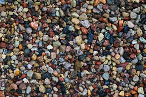 Top view of the beach with colorful stones, background.