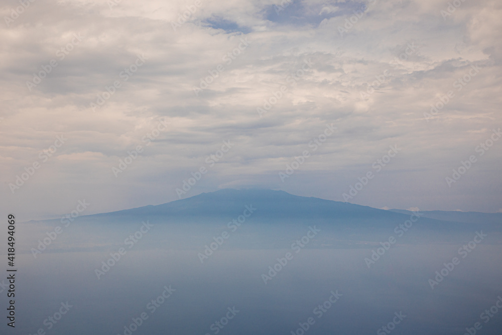 View of Mount Etna from the deck of a plane flying to Catania. Sicily Italy Summer 2020. View of Mount Etna from the deck of a plane flying to Catania. Sicily Italy Summer 2020.