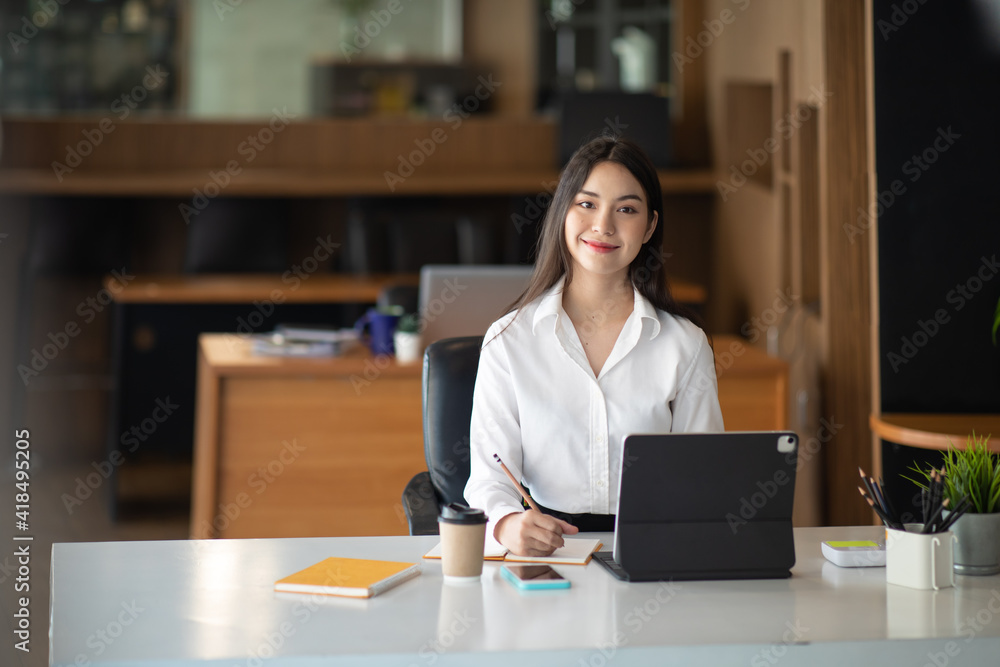 Shot of a asian young business Female working on laptop in her workstation. Shot of a asian young business Female working on laptop in her workstation.