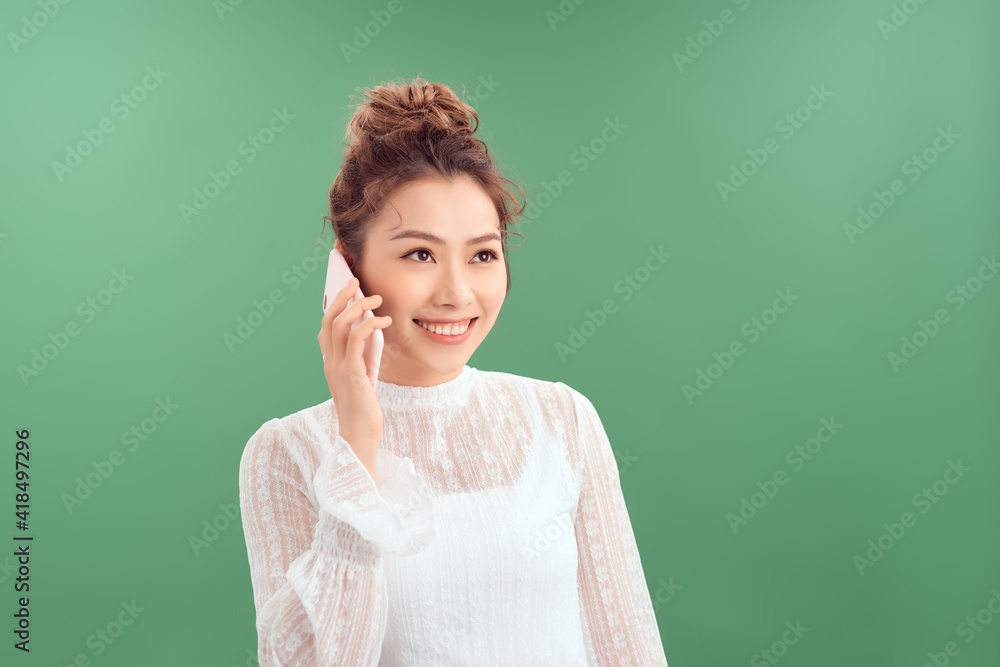 Cheerful pretty young woman talking on cellphone Cheerful pretty young woman talking on cellphone
