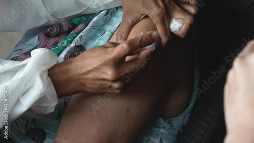 Nurse at immunization campaign is Making a Vaccine Injection to a elderely. Needle and a Syringe at corona virus vaccination campaign 
 photo