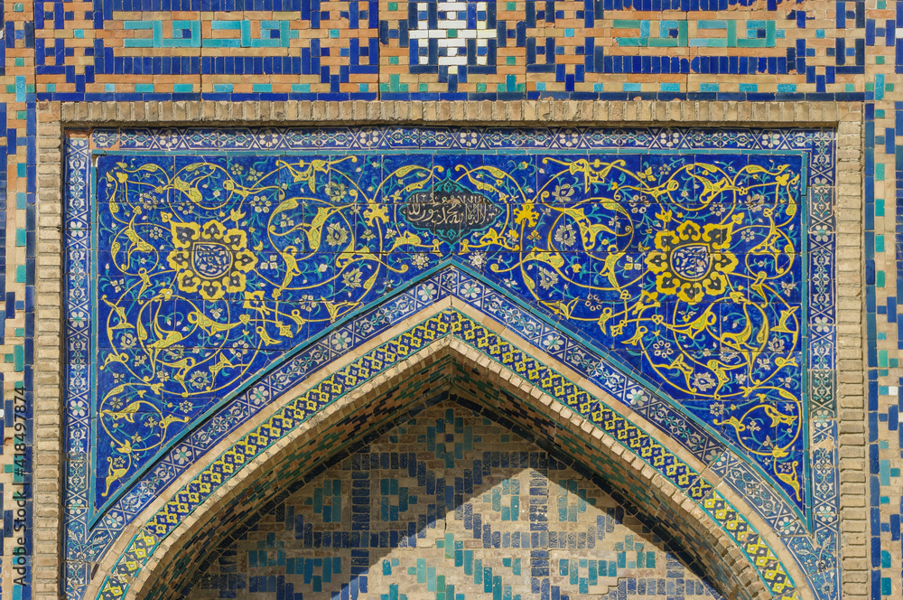 Beautiful blue mosaic decor in the courtyard of ancient Tilya Kori madrassa in UNESCO listed Samarkand, Uzbekistan