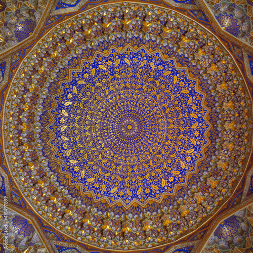 Beautiful gold and blue decor on ceiling of ancient Tilya Kori madrassa on Registan square in UNESCO listed Samarkand, Uzbekistan