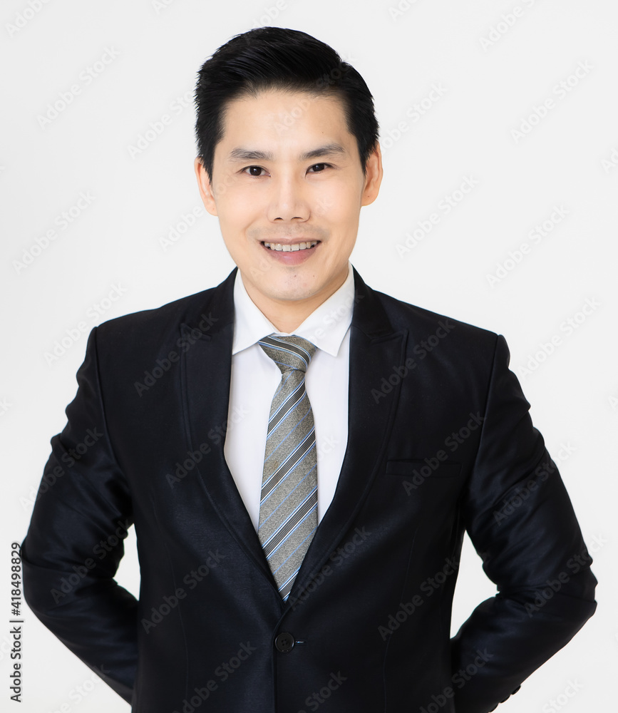 Young and handsome black hair Asian businessman in dark tone suit standing and looking to camera, pose with self-confidence and trust Young and handsome black hair Asian businessman in dark tone suit standing and looking to camera, pose with self-confidence and trust