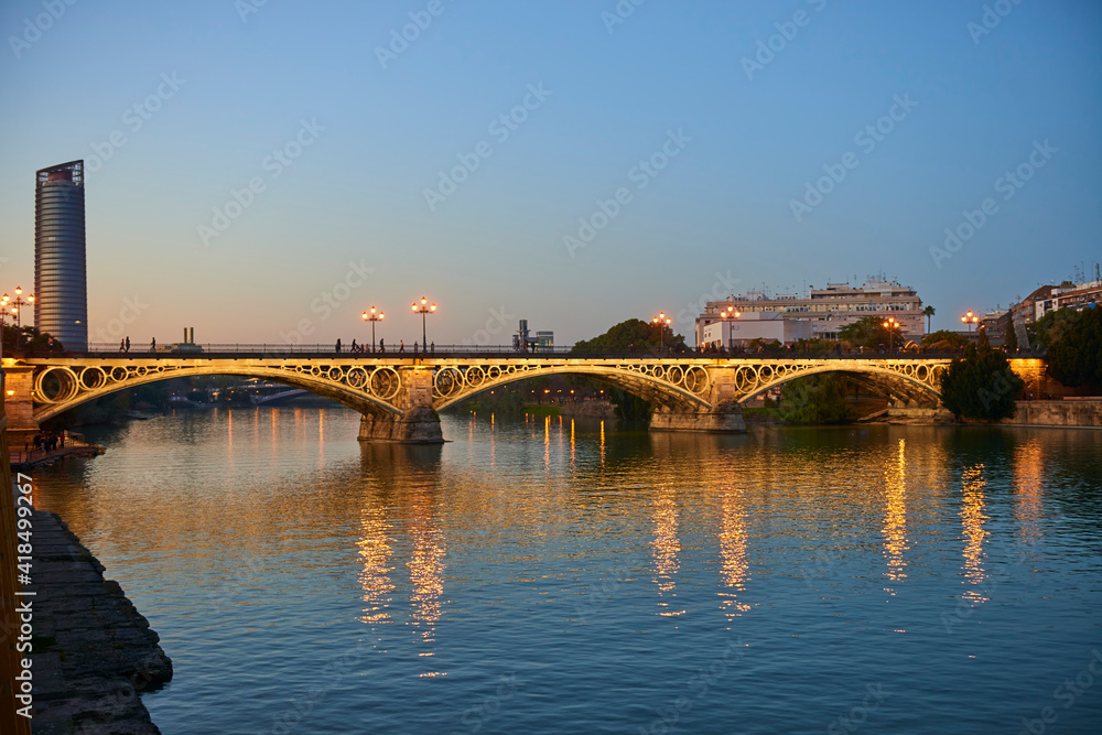 Isabel II bridge or Triana bridge, in Guadalquivir river at Evening,Sevilla,Andalucía,Spain, Europe.