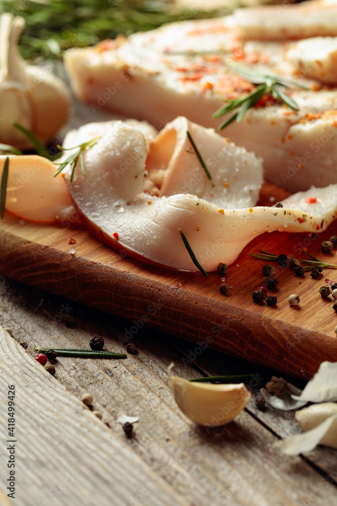 Lard with spices and herbs on a old wooden table. Lard with spices and herbs on a old wooden table.