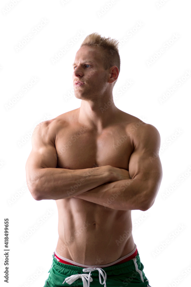 Shirtless muscular young man standing with arms crossed on chest, looking away to a side, isolated on white Shirtless muscular young man standing with arms crossed on chest, looking away to a side, isolated on white