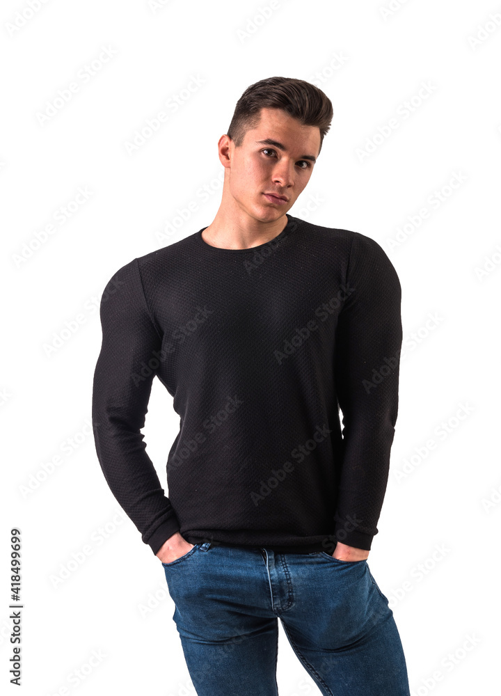 Cool young man with wool sweater on white background looking at camera, with hands in pockets of jeans pants Cool young man with wool sweater on white background looking at camera, with hands in pockets of jeans pants