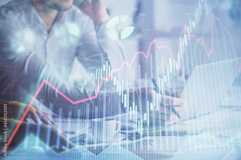 Multi exposure of man and woman working together and financial chart hologram. Business concept. Computer background. Multi exposure of man and woman working together and financial chart hologram. Business concept. Computer background.