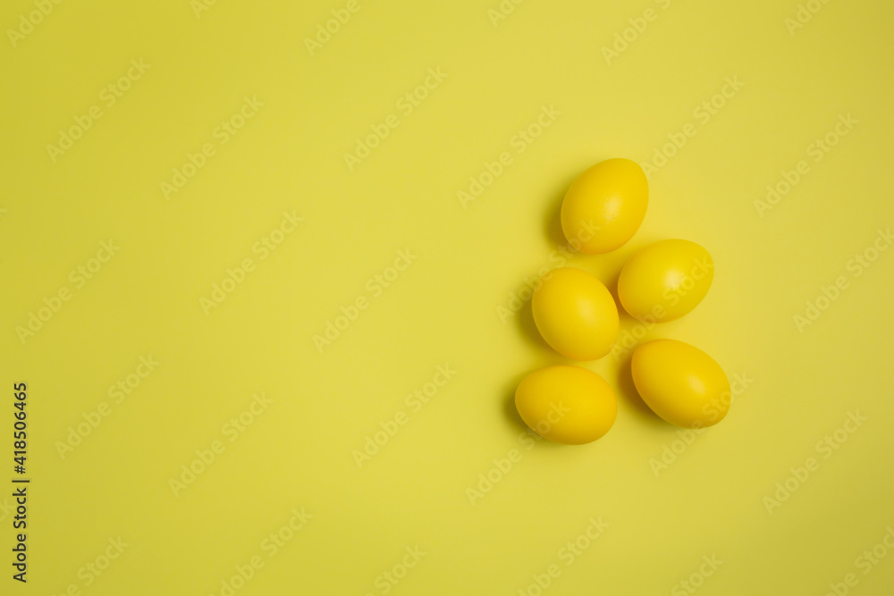 Yellow easter eggs isolated on yellow background with copy space. Trendy colour 2021. Happy Easter. Yellow easter eggs isolated on yellow background with copy space. Trendy colour 2021. Happy Easter.