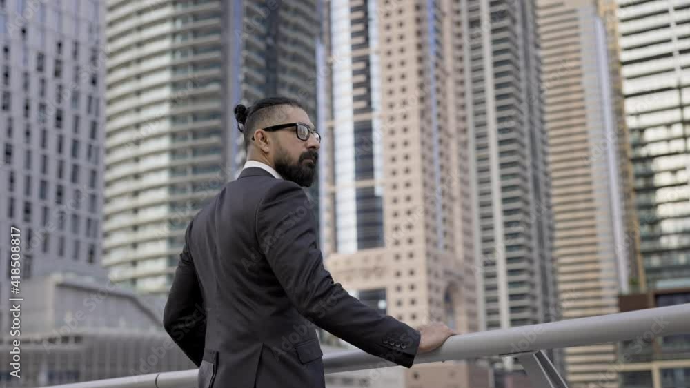 Stylish Young Man In Business Suit On Background Of The City. Tall Buildings Dubai. Confident Businessman. Stylish Young Man In Business Suit On Background Of The City. Tall Buildings Dubai. Confident Businessman.