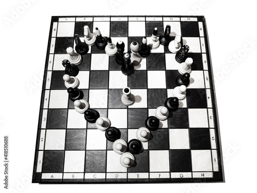 Heart from chess pieces on a chessboard