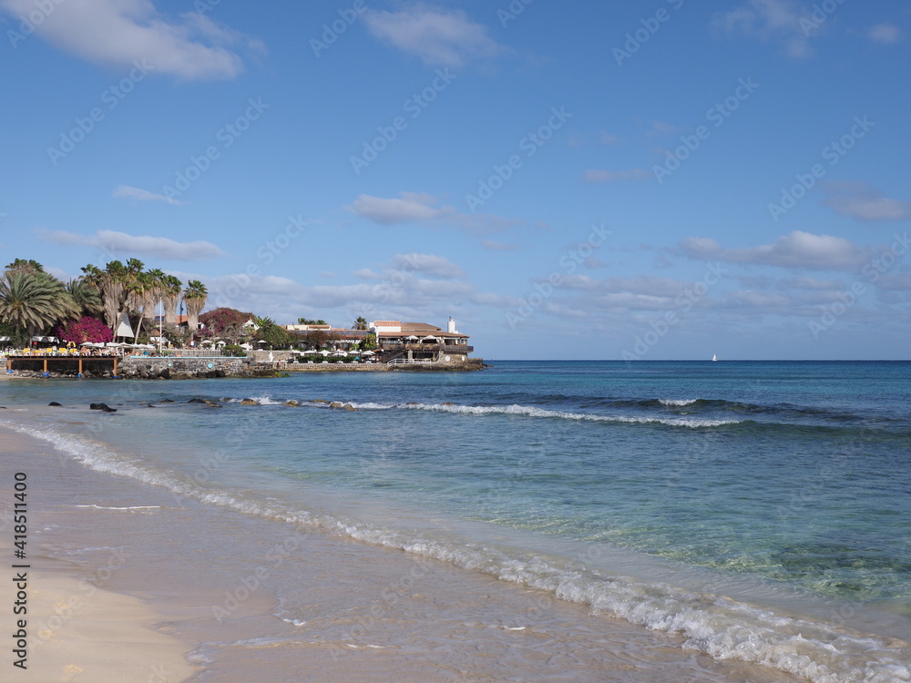 Tropical beach and palms on Atlantic Ocean in african Santa Maria town at Sal island in Cape Verde, clear blue sky in 2019 warm sunny spring day on March.