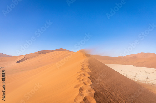 The desert dunes on a sunny and windy day, Deadvlei, Sossusvlei, Namibia, Africa.