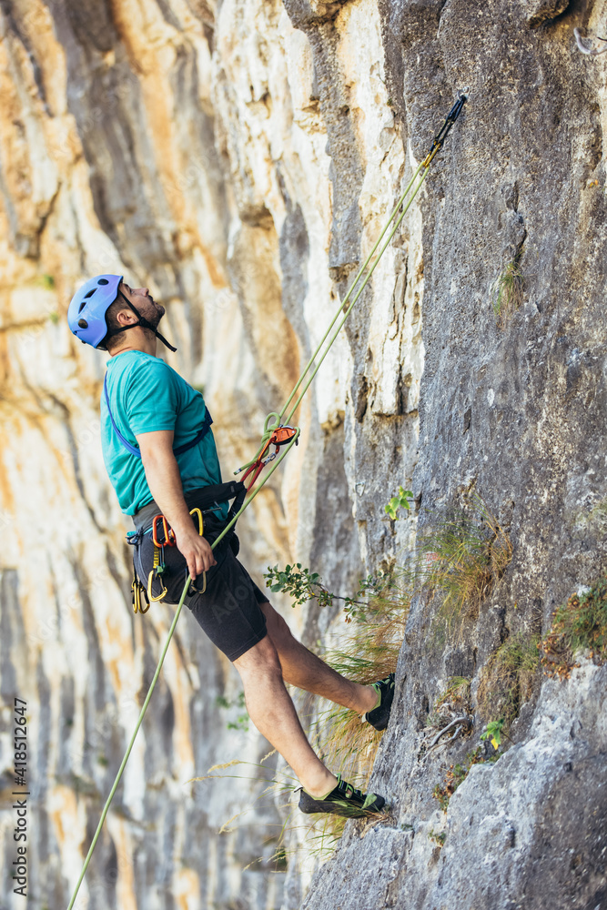 Climber climbs on the rock wall. Climbing gear. Climbing equipment. Climber climbs on the rock wall. Climbing gear. Climbing equipment.