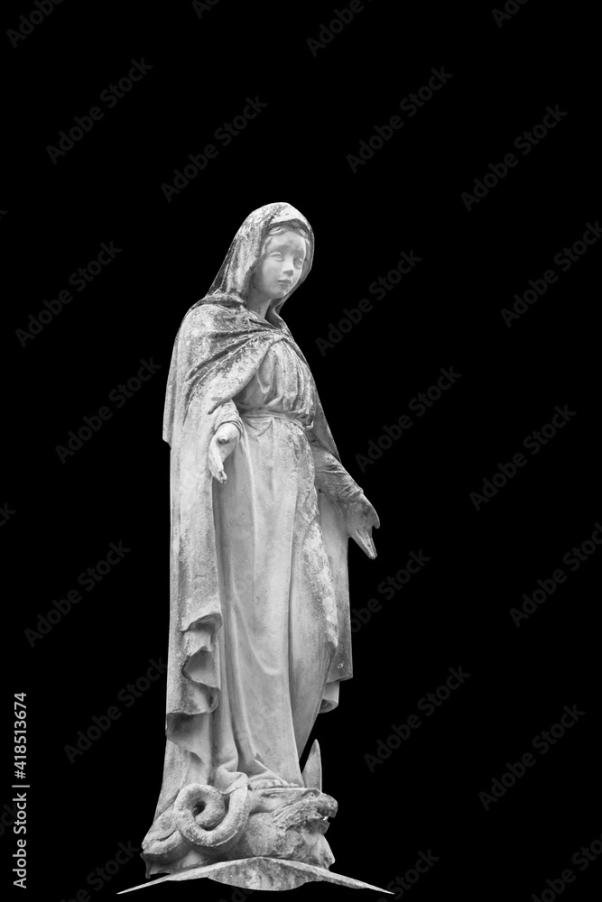 Antique satue of Virgin Mary isolated on black background.