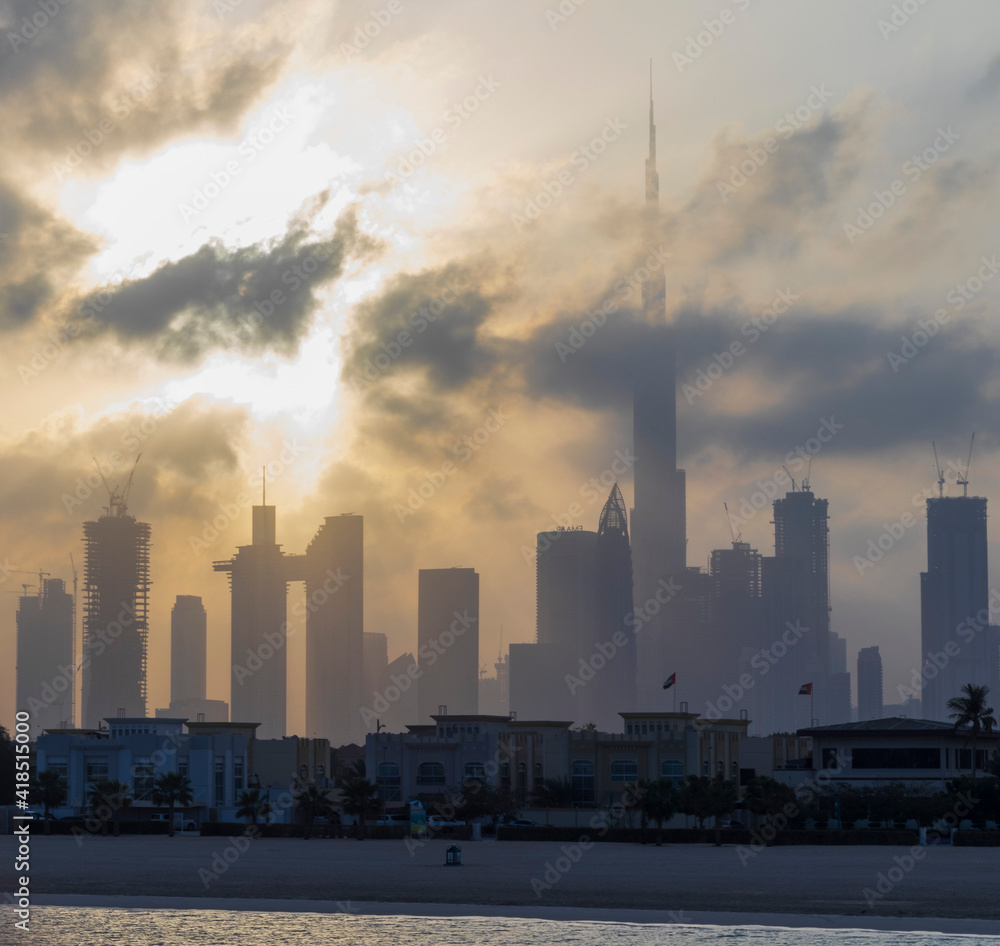 Dubai, UAE - 03.06.2021 Dubai public beach with city skyline on background.Sunrise hour. Outdoor Dubai, UAE - 03.06.2021 Dubai public beach with city skyline on background.Sunrise hour. Outdoor