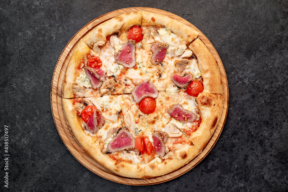 delicious meat pizza on a stone background delicious meat pizza on a stone background