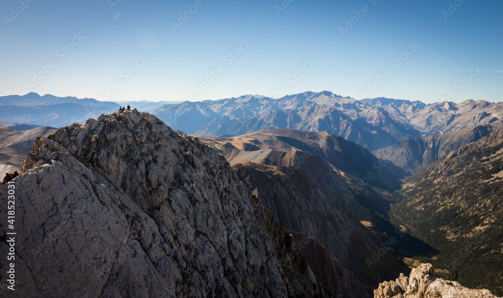Climbers at the top of a mountain in the Pyrenees on a sunny summer day