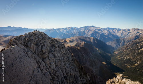 Climbers at the top of a mountain in the Pyrenees on a sunny summer day