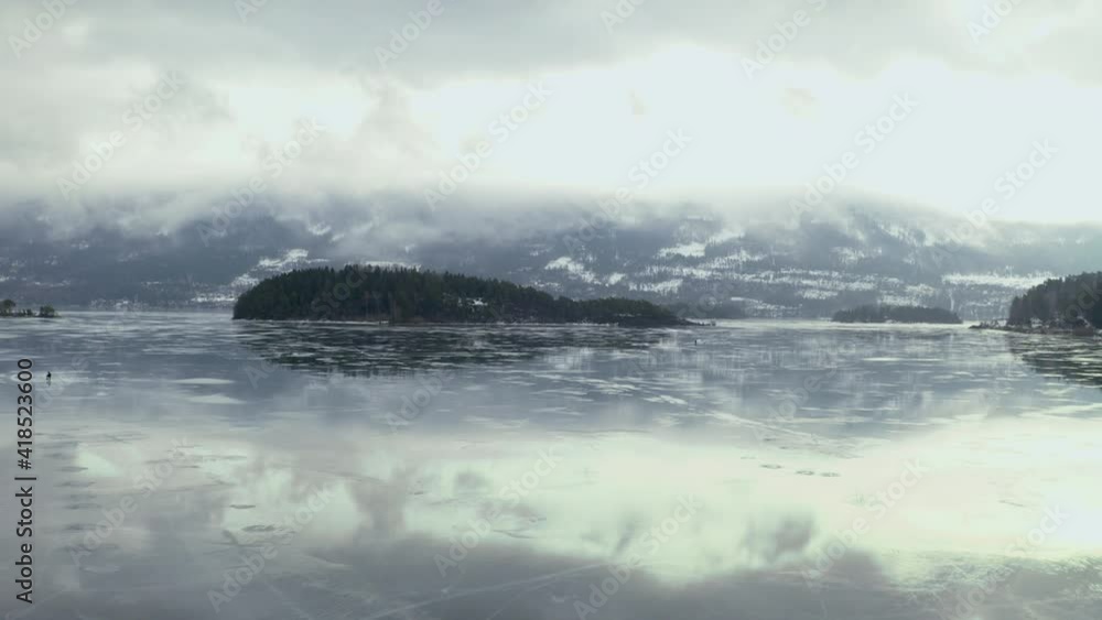 Misty View Of Frozen Lake In Vik Norway - aerial shot Misty View Of Frozen Lake In Vik Norway - aerial shot