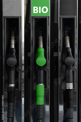 Photo Fuel nozzles at a gas station. One nozzle green with text BIO.