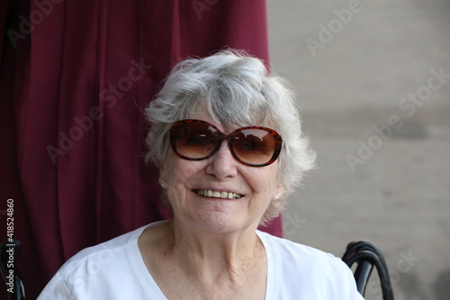 Woman with sunglasses enjoying her grandson's graduation day