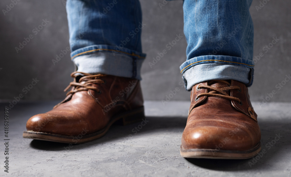 men's legs in jeans and old travel vintage leather boots